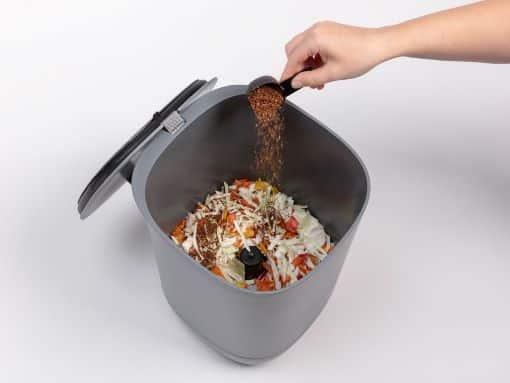 bokashi compost bin with kitchen waste and composting material